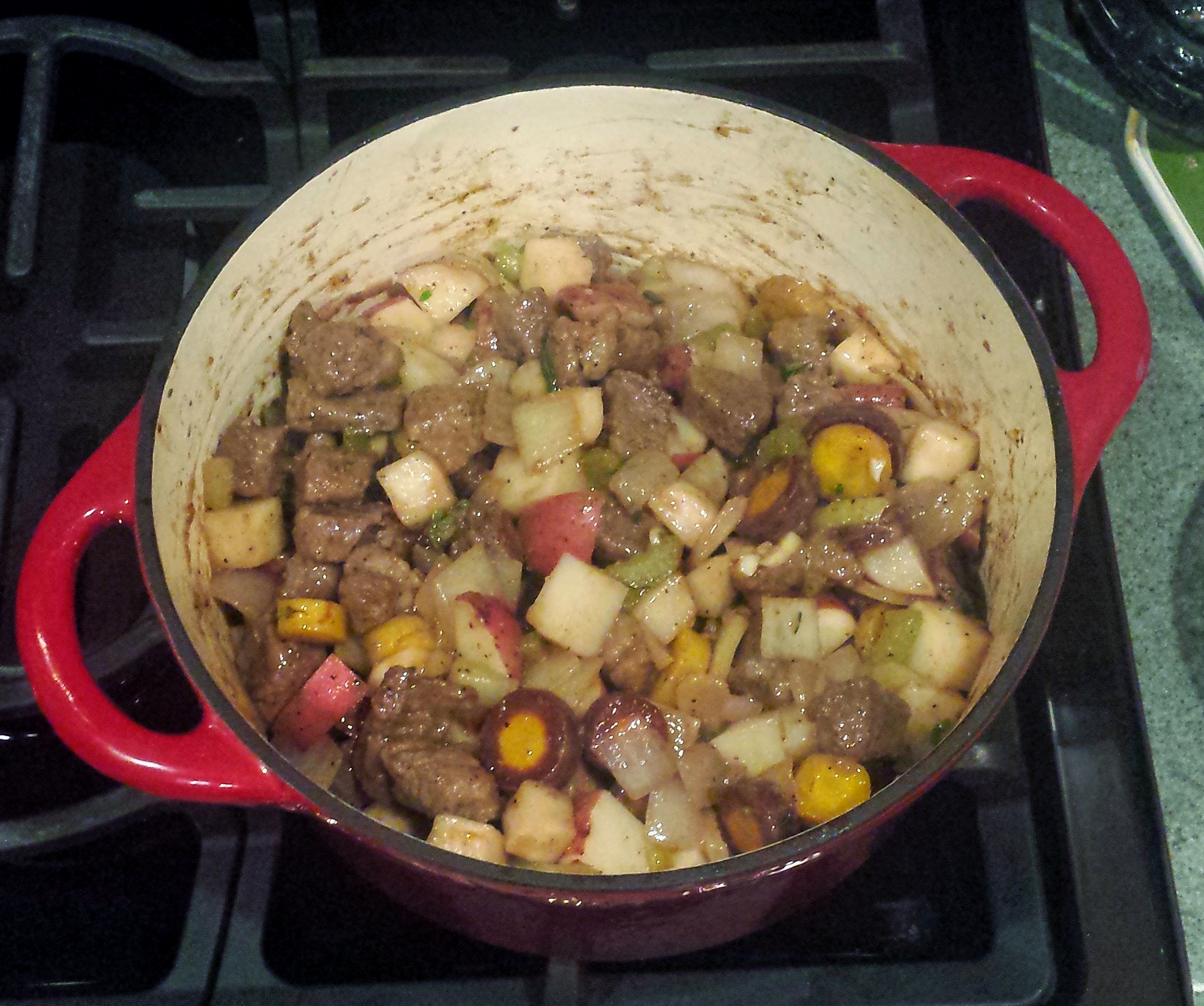The beef has been added to the vegetables and spices.